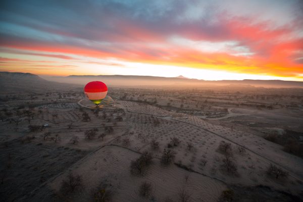 aerial shoot of a balloon at magic sunrise in kapadokia