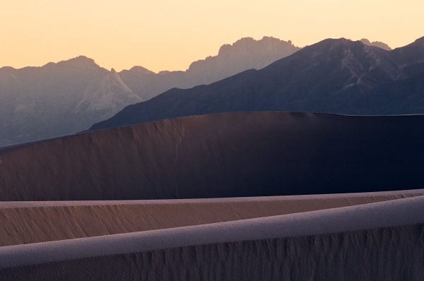 Sunset view of white sand dunes and mountains new mexico